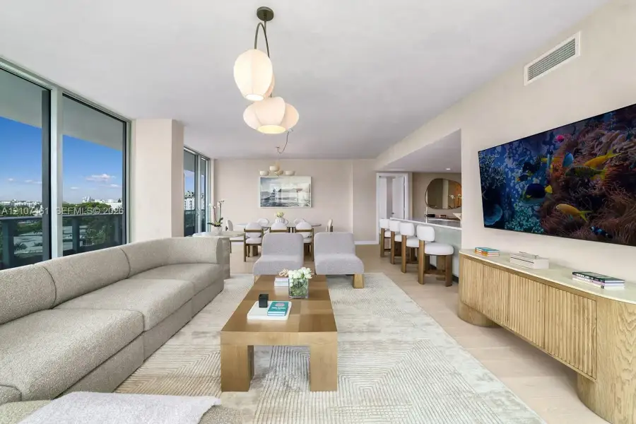 Floor-to-ceiling glass wall, light-toned wood-finish flooring, custom built-in cabinetry, and multi-tier sculptural pendant lighting Floor-to-ceiling glass wall, light-toned wood-finish flooring, custom built-in cabinetry, and multi-tier sculptural pendant lighting