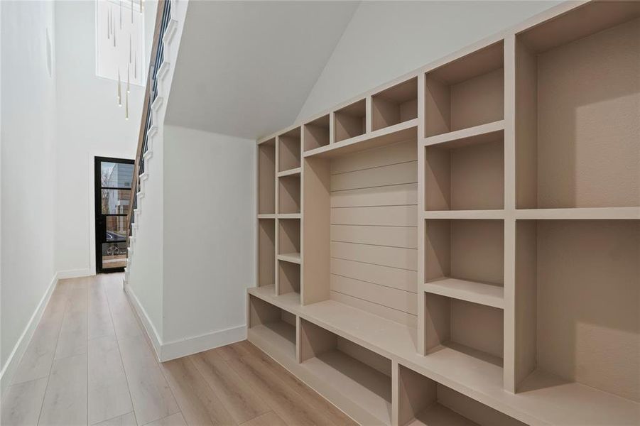 Mudroom featuring light wood-style floors and lofted ceiling Mudroom featuring light wood-style floors and lofted ceiling