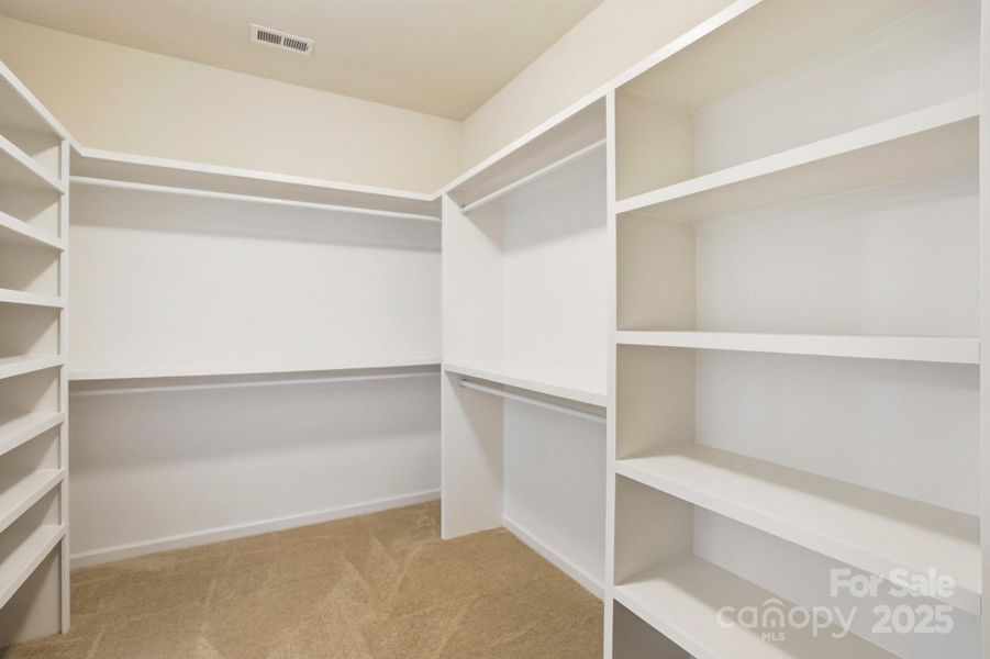 Primary bath with dual vanities and walk-in tile shower Primary bath with dual vanities and walk-in tile shower