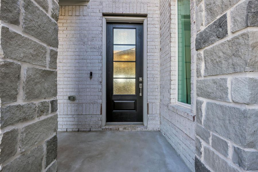 Are you ready to enter the main home? Main Entry: A recessed entry framed by stone and brick creates a calm, welcoming approach. The modern front door sets a clean, understated tone before stepping inside. Are you ready to enter the main home? Main Entry: A recessed entry framed by stone and brick creates a calm, welcoming approach. The modern front door sets a clean, understated tone before stepping inside.