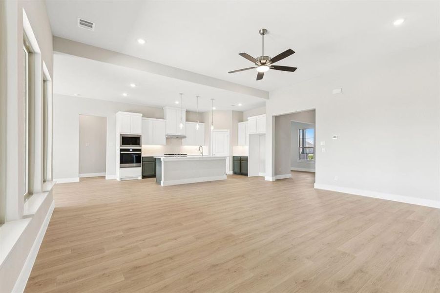 Unfurnished room featuring light wood-style flooring and ceiling fan Unfurnished room featuring light wood-style flooring and ceiling fan