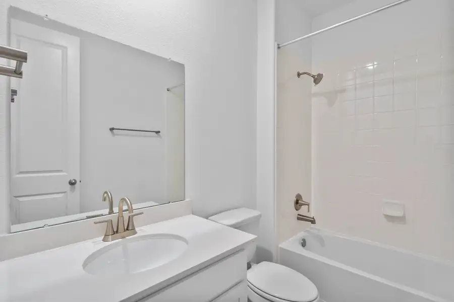 Classically designed secondary bath featuring the AW Timeless Collection with crisp white cabinetry and light countertops with nickel fixtures and a shower/tub combo. Classically designed secondary bath featuring the AW Timeless Collection with crisp white cabinetry and light countertops with nickel fixtures and a shower/tub combo.