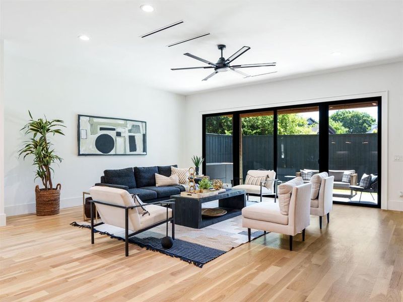 Living room featuring light wood-style floors, recessed lighting, and ceiling fan