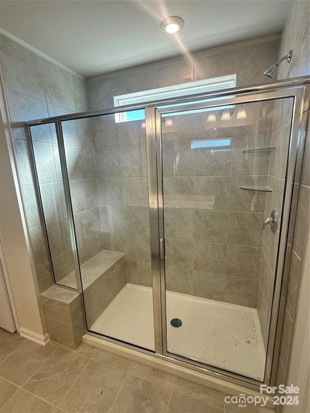 Representative primary suite shower with seat