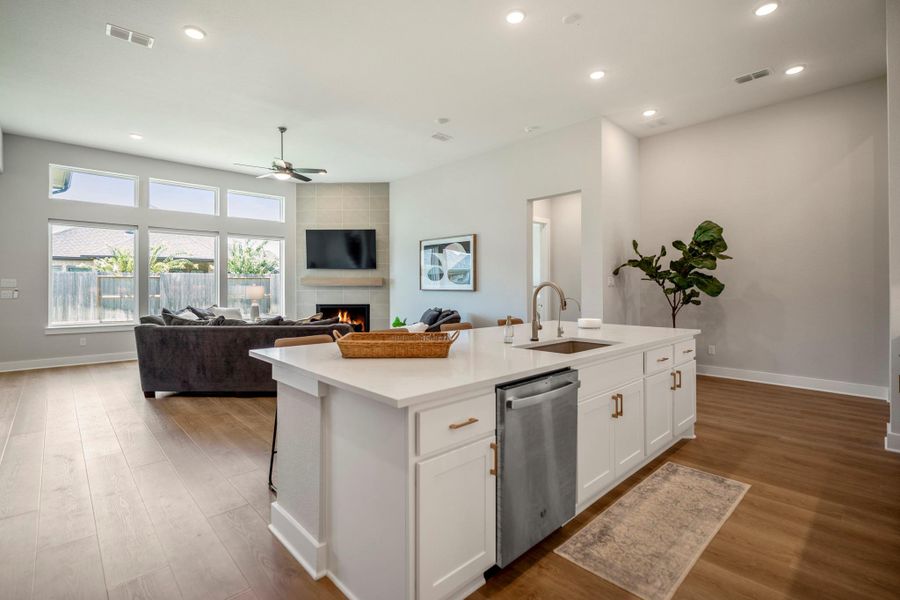 The open flow from the island kitchen to the family room makes daily living more comfortable, keeping everyone connected while meals are prepared, conversations continue and everyone settles in together.