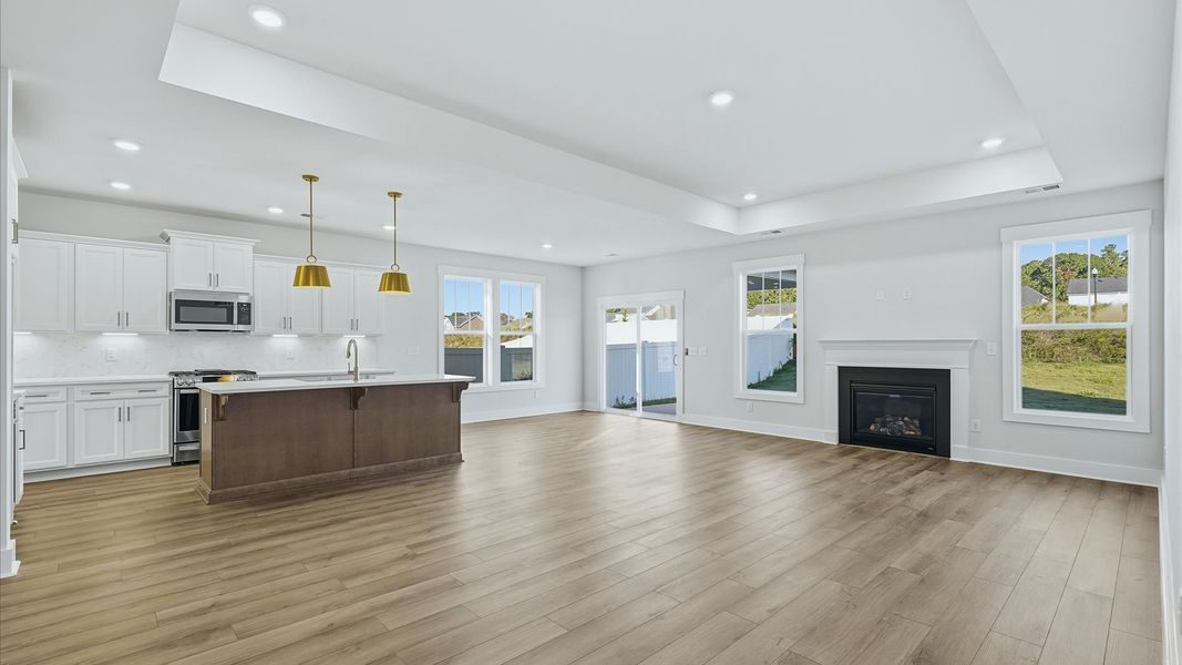 Memorable moments begin in this elegant, open family room with hardwood flooring and refined finishes by DRB Homes