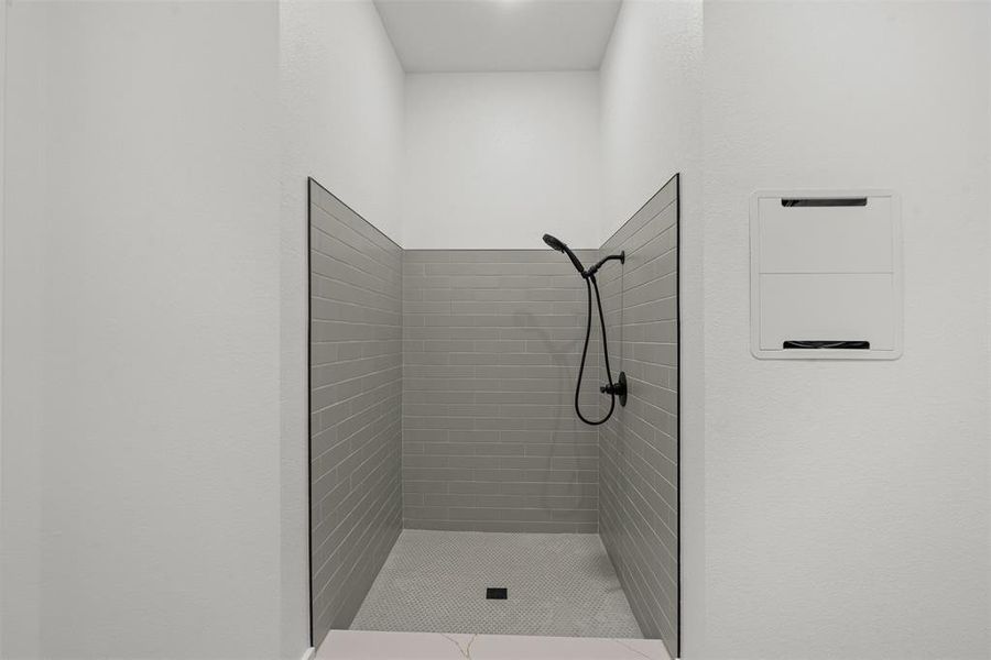 Full bathroom featuring a shower stall