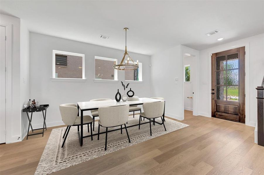 Spacious room featuring wood-finish flooring, white walls, and bright white trim