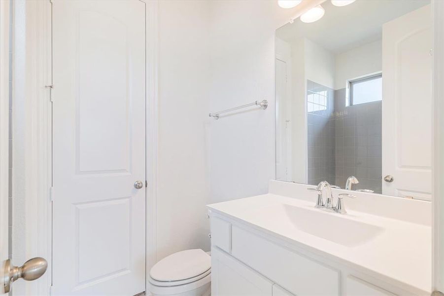 Bathroom featuring oversized vanity and toilet