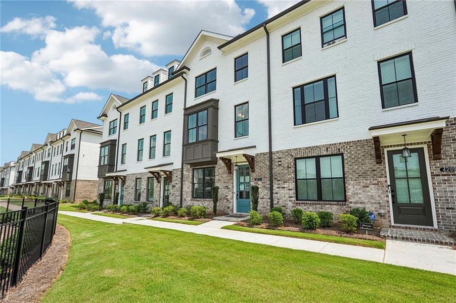 Front exterior of a new home in Millcroft Townhomes, Buford, GA, highlighting curb appeal (Image 31). Front exterior of a new home in Millcroft Townhomes, Buford, GA, highlighting curb appeal (Image 31).