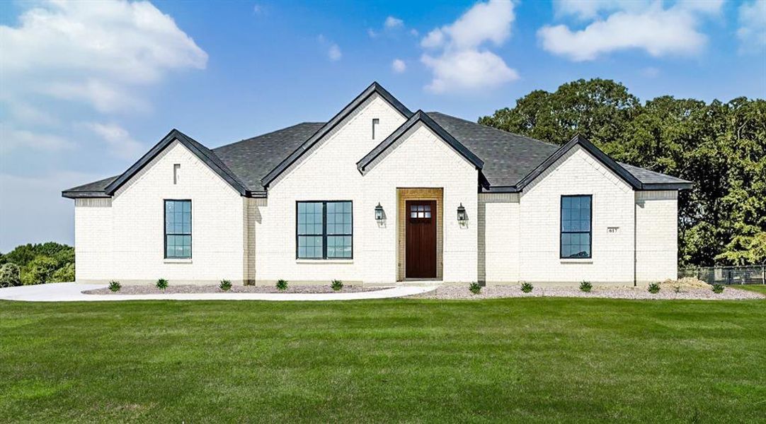 Front exterior of a new home in Rocky Top Ranch, Reno, TX, highlighting curb appeal (Image 1). Front exterior of a new home in Rocky Top Ranch, Reno, TX, highlighting curb appeal (Image 1).