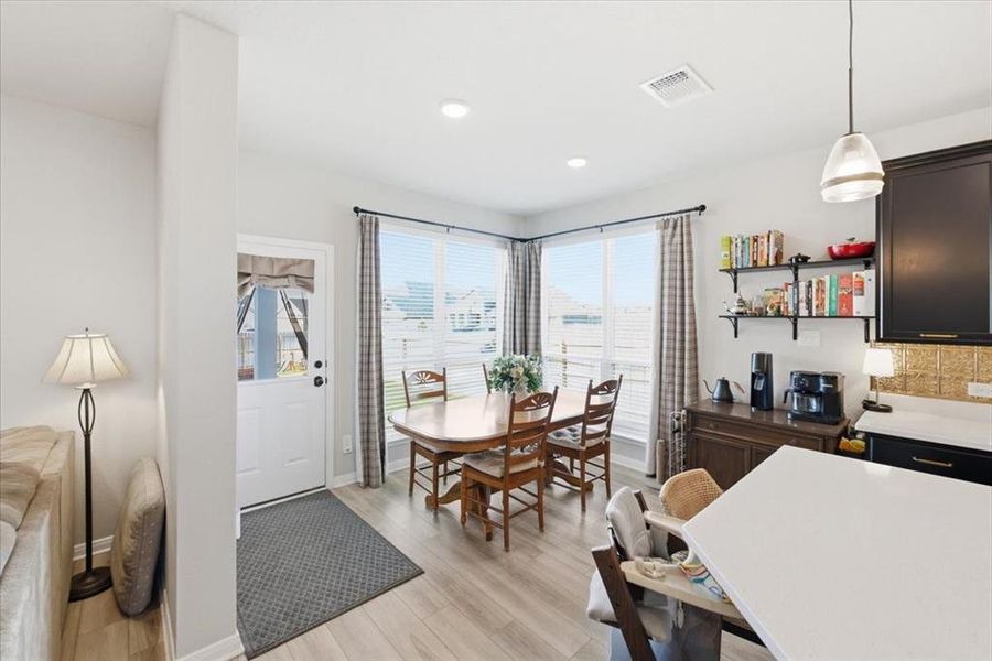 Naturally well lit dining space featuring light wood-type flooring Naturally well lit dining space featuring light wood-type flooring