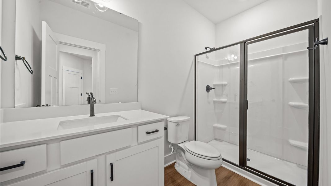 Highly skilled design seen in this polished and practical full bathroom