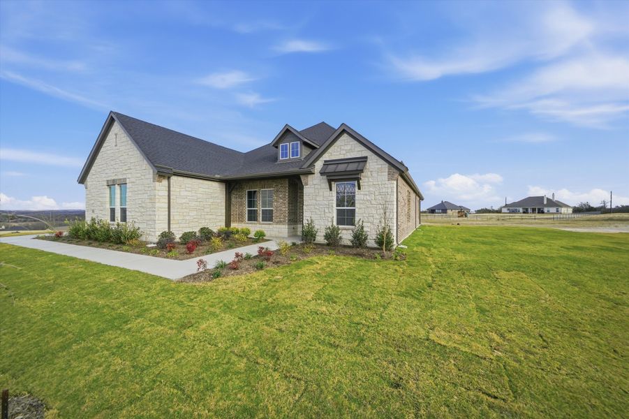 Front exterior of a new home in Eagle Ridge Estates, Weatherford, TX, highlighting curb appeal (Image 23).
