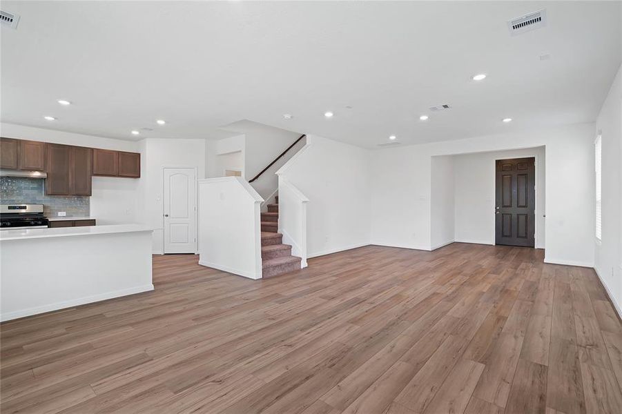 Another gorgeous view of the Great Room with views to the front door, kitchen, and staircase leading to the 2nd floor.