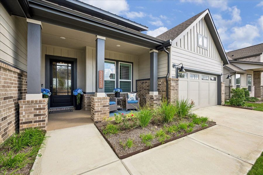 This spacious three-car tandem garage features durable epoxy flooring with ample additional space for storage, a workshop, or a home gym.