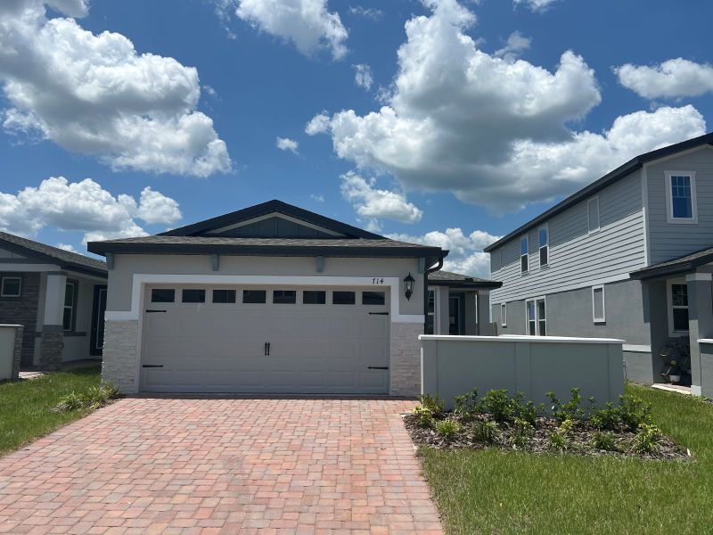 Front exterior of a new home in Springs at Lake Alfred - Classic Series, Lake Alfred, FL, highlighting curb appeal (Image 1). Front exterior of a new home in Springs at Lake Alfred - Classic Series, Lake Alfred, FL, highlighting curb appeal (Image 1).