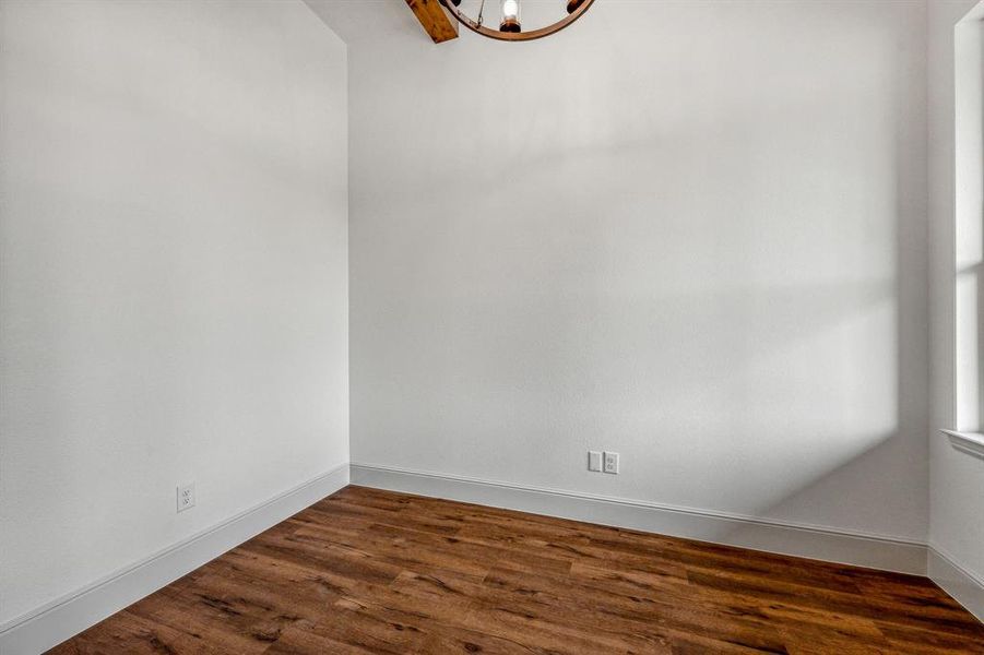 Spare room featuring wood-type flooring