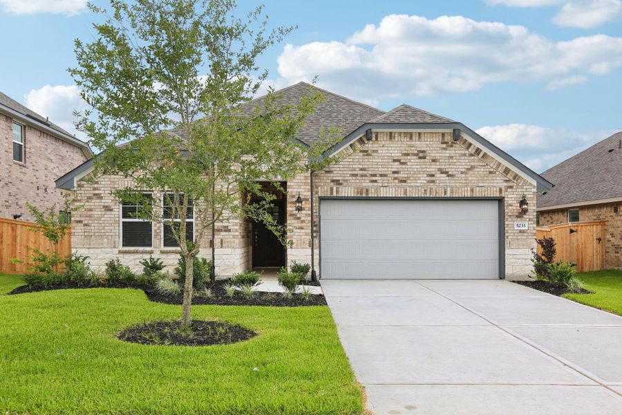 Front exterior of a new home in Massey Oaks - Premier Series, Pearland, TX, highlighting curb appeal (Image 1). Front exterior of a new home in Massey Oaks - Premier Series, Pearland, TX, highlighting curb appeal (Image 1).