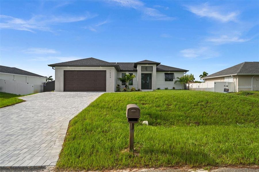 Front exterior of a new home in , Cape Coral, FL, highlighting curb appeal (Image 21). Front exterior of a new home in , Cape Coral, FL, highlighting curb appeal (Image 21).