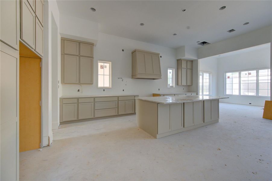 Under construction and already showcasing exceptional scale and design, this future chef’s kitchen features soaring ceilings, custom cabinetry, an oversized island, and an open-concept layout designed for luxury living and entertaining.