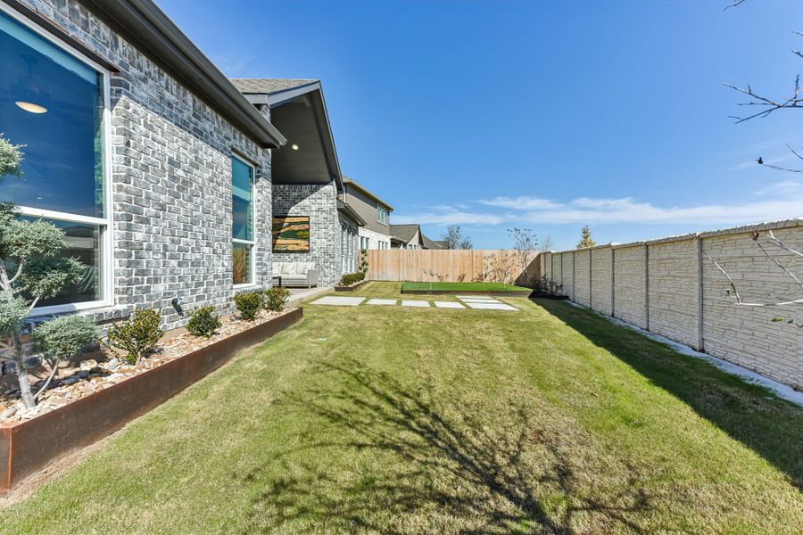 Exterior details and patio area of a home in The Grove at Blackhawk, Pflugerville (Image 37).