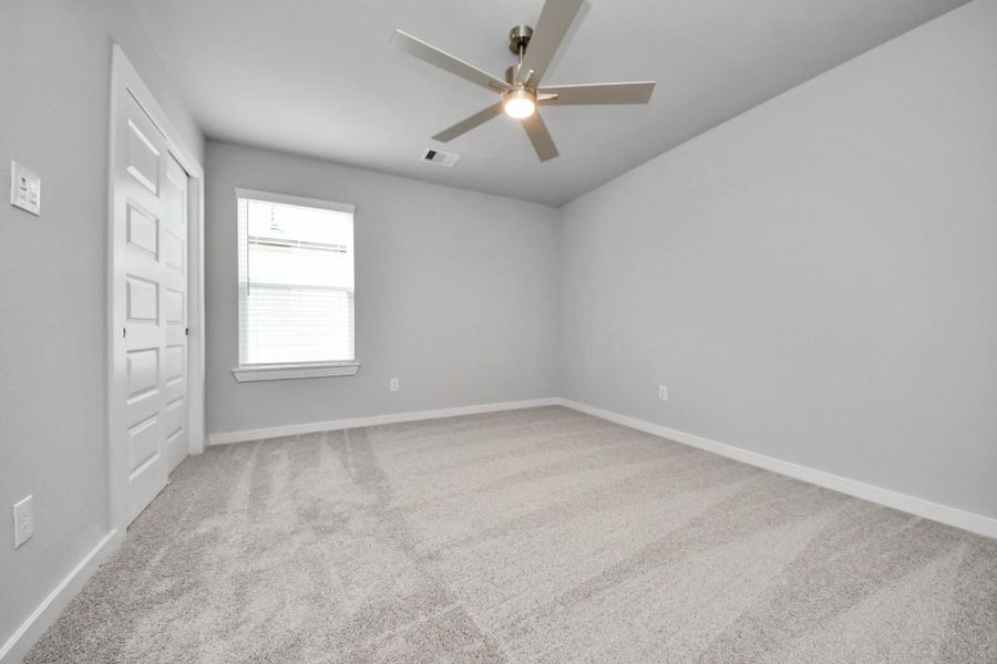 Generously sized secondary bedrooms featuring spacious closets, soft and inviting carpeting underfoot, large windows allowing plenty of natural light, and the added touch of privacy blinds for your personal retreat.