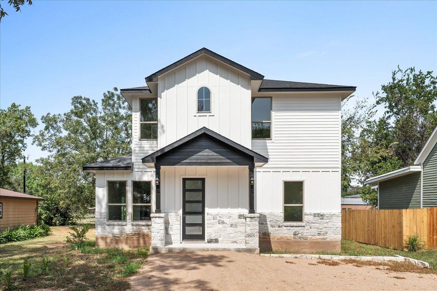 Modern inspired farmhouse with board and batten siding and stone siding