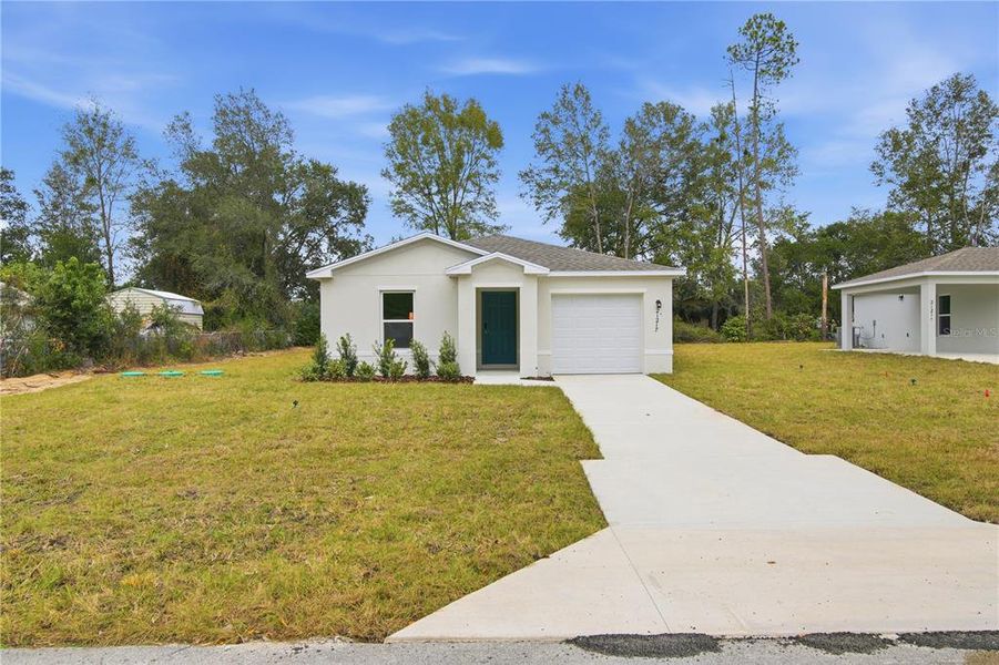 Front exterior of a new home in Rainbow Lakes Estates, Dunnellon, FL, highlighting curb appeal (Image 1). Front exterior of a new home in Rainbow Lakes Estates, Dunnellon, FL, highlighting curb appeal (Image 1).