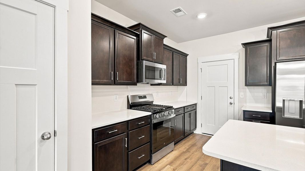 Beautifully appointed kitchen with spacious counters and sophisticated detailing