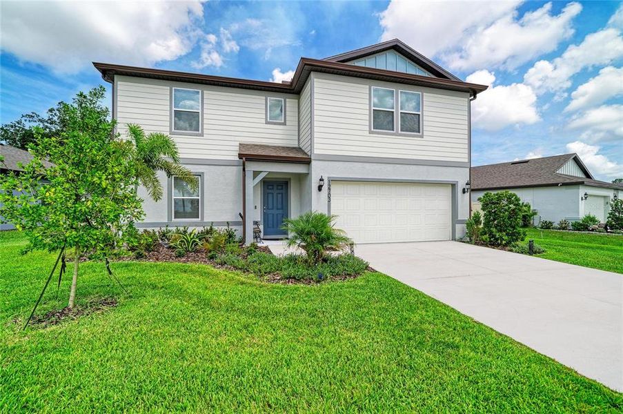 Front exterior of a new home in Oakfield Lakes, Parrish, FL, highlighting curb appeal (Image 2). Front exterior of a new home in Oakfield Lakes, Parrish, FL, highlighting curb appeal (Image 2).