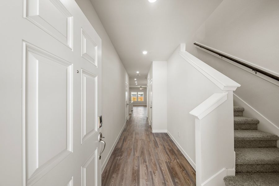 A hallway with white doors. A hallway with white doors.