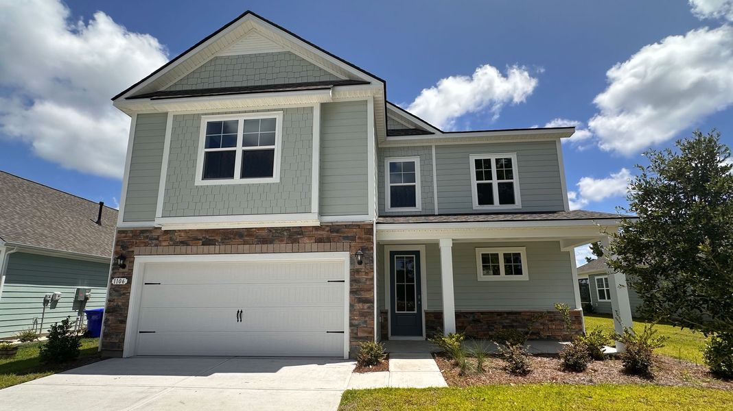 Front exterior of a new home in The Retreat at Wild Wing, Conway, SC, highlighting curb appeal (Image 1). Front exterior of a new home in The Retreat at Wild Wing, Conway, SC, highlighting curb appeal (Image 1).