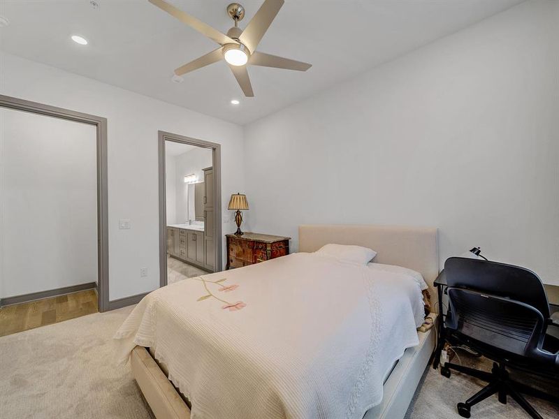 Bedroom featuring recessed lighting, ceiling fan, connected bathroom, and light wood-style flooring