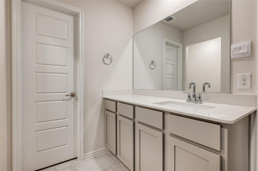 Bathroom with vanity and light tile patterned flooring
