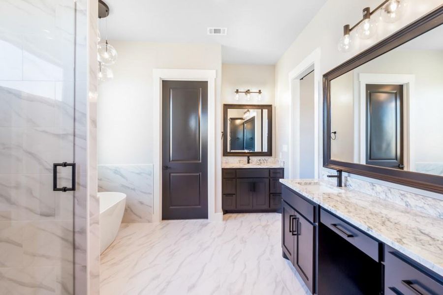 Bathroom with vanity, tile walls, and independent shower and bath