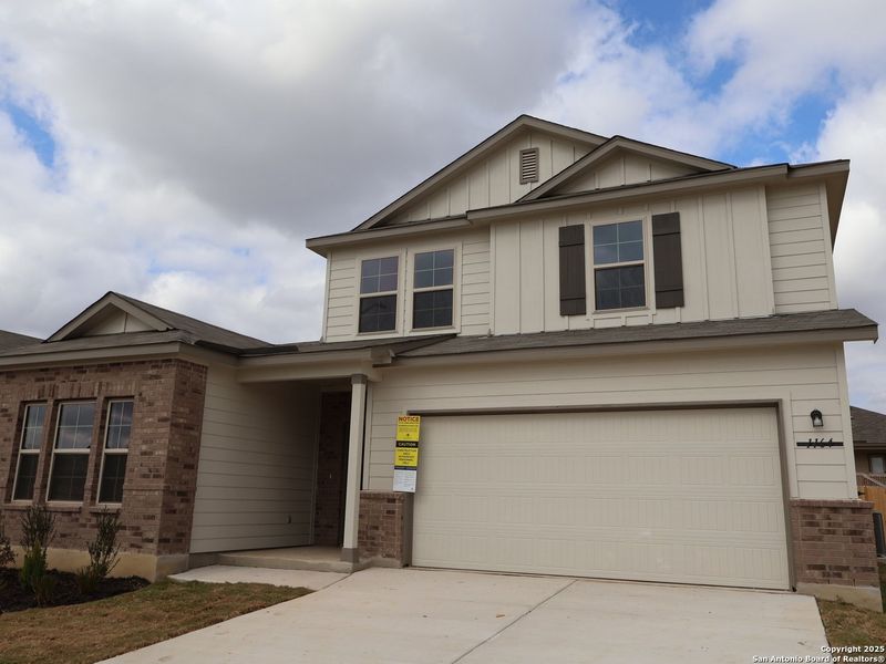 Front exterior of a new home in Greenspoint Heights, Seguin, TX, highlighting curb appeal (Image 23).