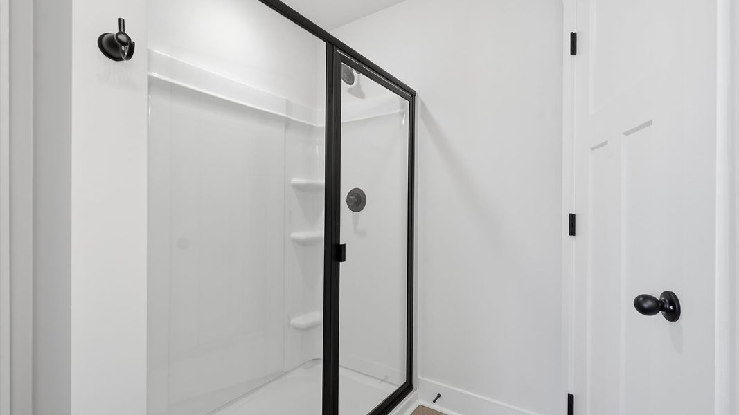 Memorable mornings begin in this elegant primary bathroom with a spacious walk-in shower and refined finishes by DRB Homes Memorable mornings begin in this elegant primary bathroom with a spacious walk-in shower and refined finishes by DRB Homes