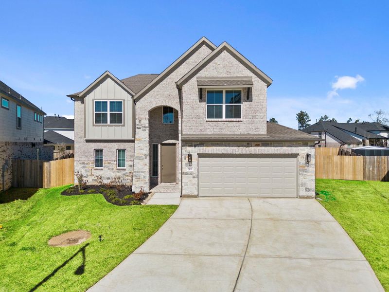 Front exterior of a new home in Barton Creek Ranch, Conroe, TX, highlighting curb appeal (Image 2). Front exterior of a new home in Barton Creek Ranch, Conroe, TX, highlighting curb appeal (Image 2).