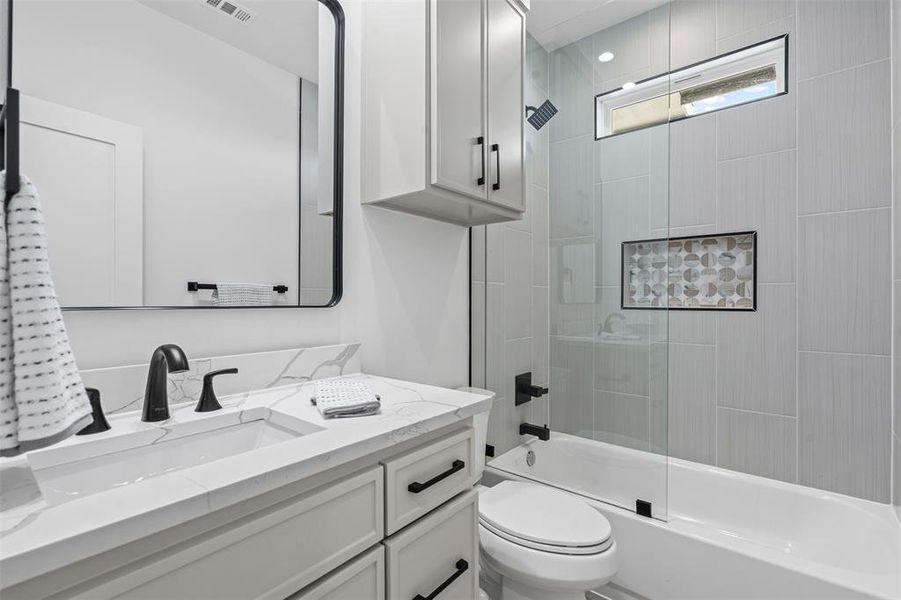 Bathroom featuring shower / bath combination with glass door and vanity