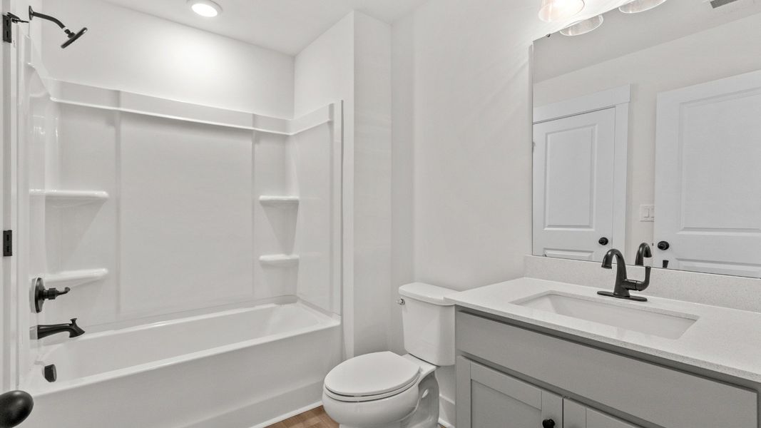 The third full bath upstairs adds style and convenience for family or guests.