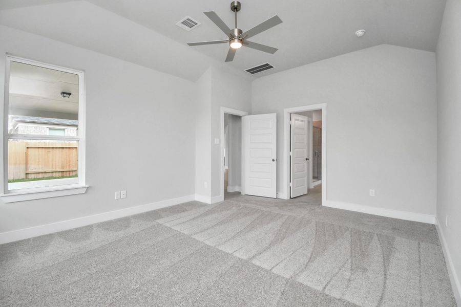 Come and unwind after a long day in this magnificent primary suite! This spacious room features plush carpet, warm paint, high ceilings and large windows with privacy blinds. Sample photo of completed home with similar floor plan. Actual colors and selections may vary. Come and unwind after a long day in this magnificent primary suite! This spacious room features plush carpet, warm paint, high ceilings and large windows with privacy blinds. Sample photo of completed home with similar floor plan. Actual colors and selections may vary.