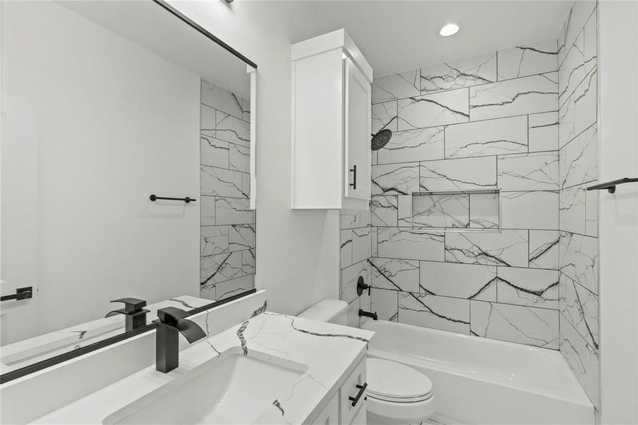 Full bathroom with vanity, toilet, and tiled shower / bath