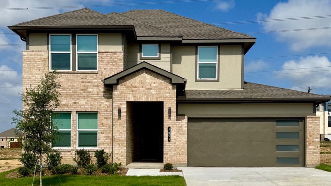 Representative exterior photo of a completed home built from the Tangerine by D.R. Horton in The Preserve at Forum, Grand Prairie, TX (Image 20).