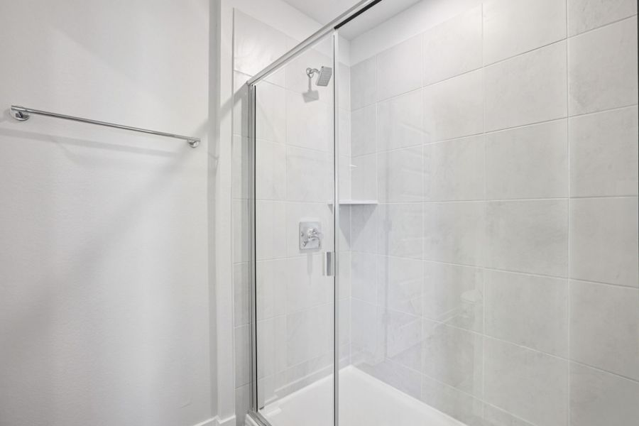 A shower with a glass door.
