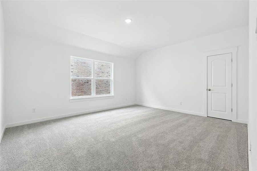 Spare room featuring carpet floors, vaulted ceiling, and recessed lighting Spare room featuring carpet floors, vaulted ceiling, and recessed lighting