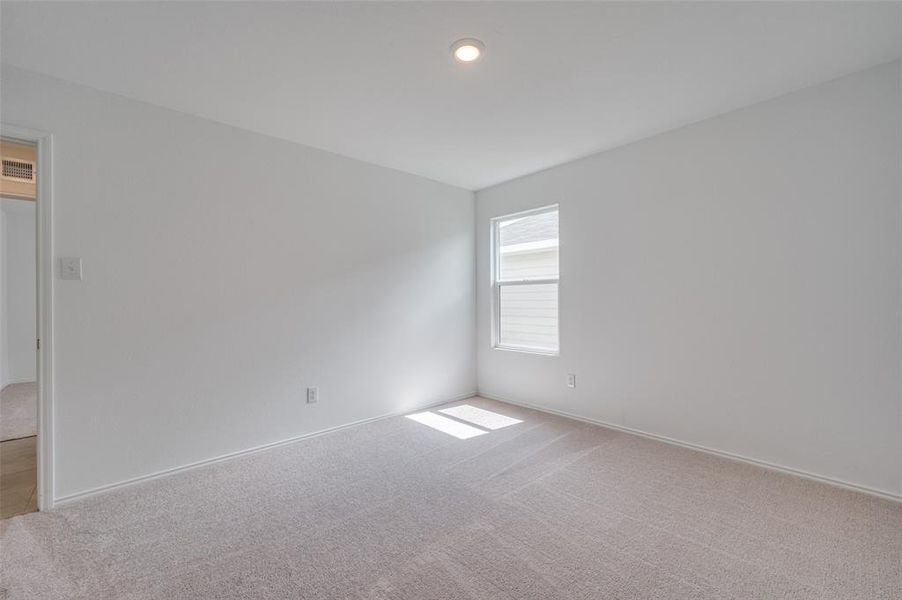 Spare room featuring carpet flooring Spare room featuring carpet flooring