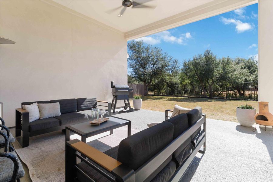 Private, level backyard featuring an oversized covered patio backing to green belt Private, level backyard featuring an oversized covered patio backing to green belt