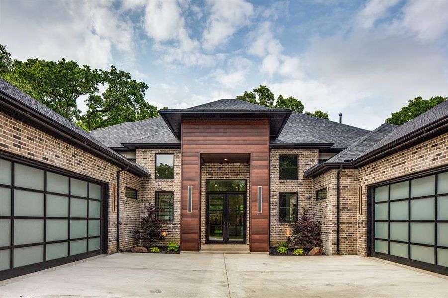 View of front facade with a garage and french doors