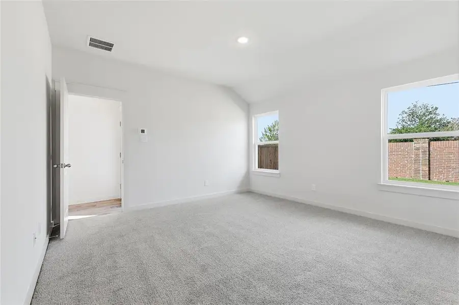 Spare room with light carpet, lofted ceiling, and recessed lighting Spare room with light carpet, lofted ceiling, and recessed lighting